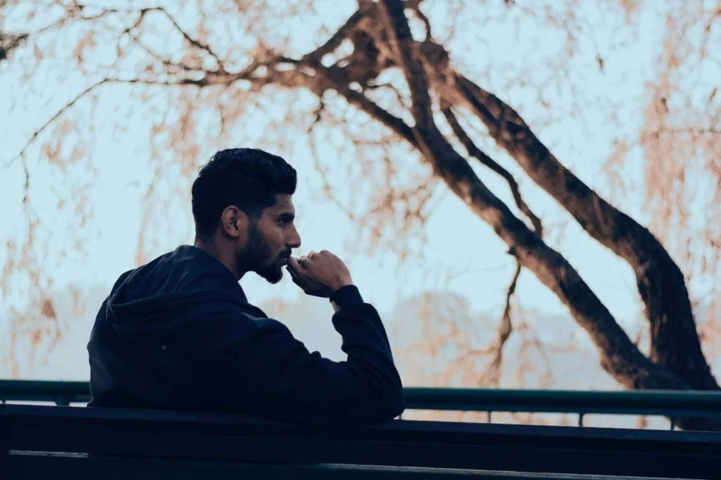 guy on a bench thinking about overcoming stagnation