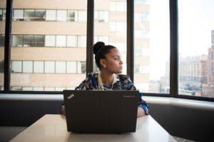 a woman with a laptop sitting in an offie