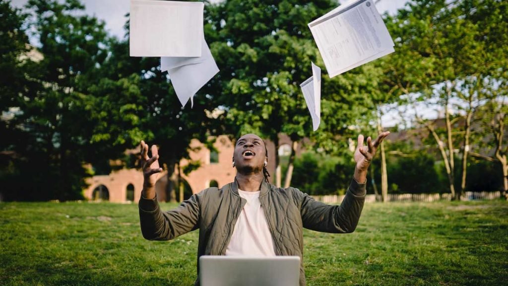 a-man-throwing-papers-in-the-air-Prioritizing-Yourself
