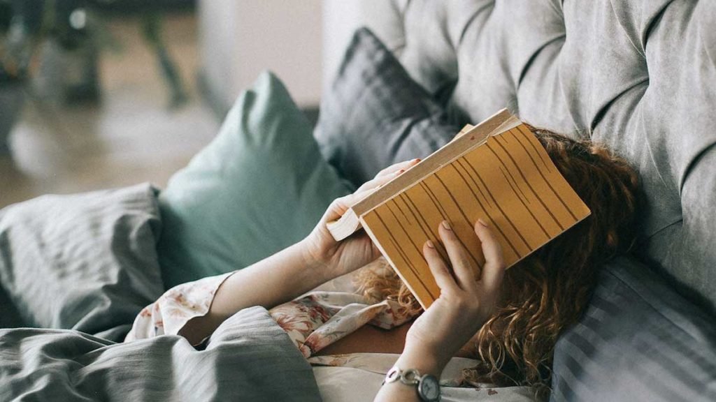 woman-with-a-book-over-her-face-not-Prioritizing-Yourself