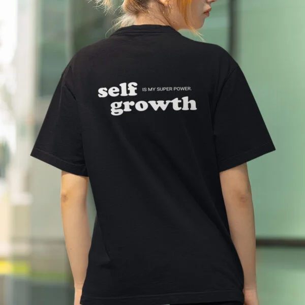 back view of a. woman wearing a self growth is my superpower tshirt